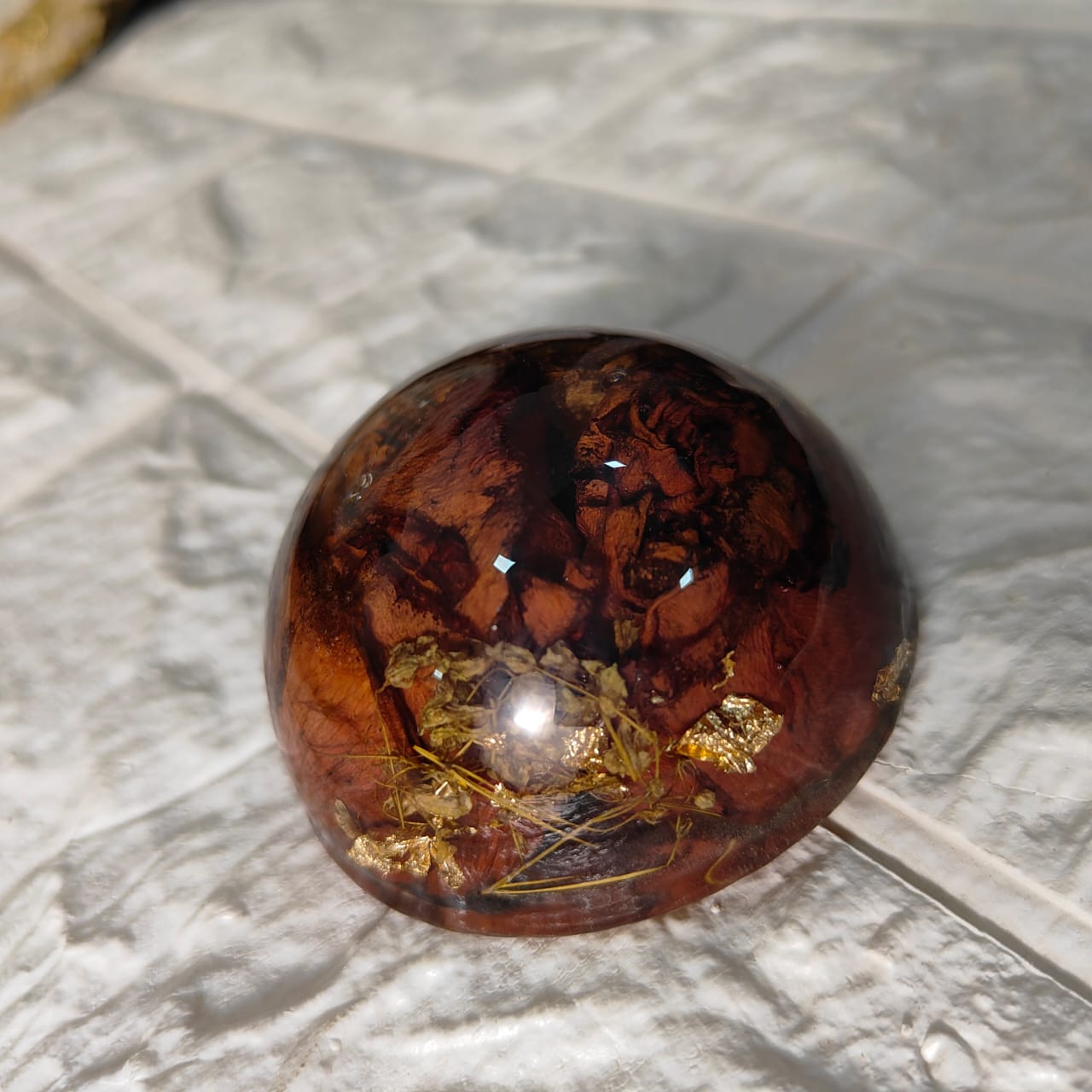 Paperweight with preserved varmala petals
